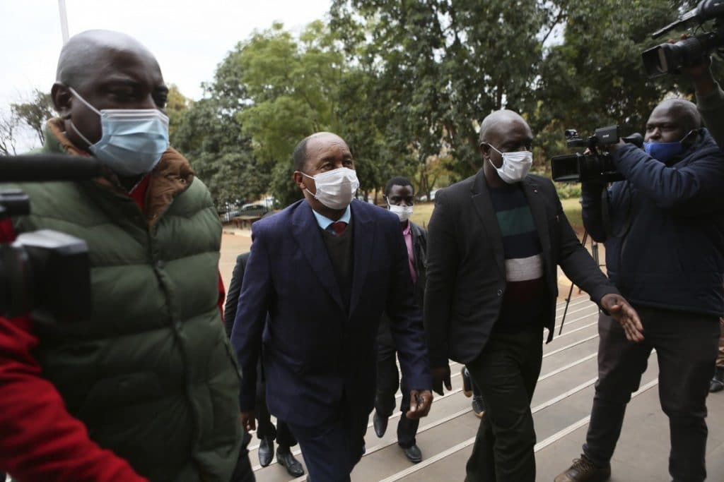 Zimbabwe’s Health minister, Obadiah Moyo, centre, makes a court appearance at the magistrates courts in Harare. Photo: AP Photo